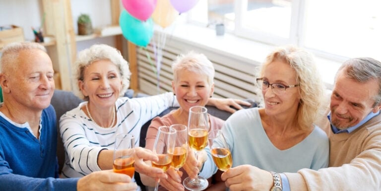 Group of Seniors Toasting Champagne at a Social Event at an Independent Living Facility