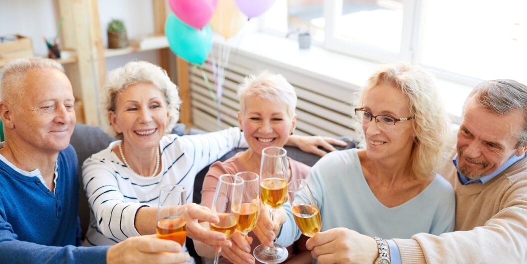 Group of Seniors Toasting Champagne at a Social Event at an Independent Living Facility