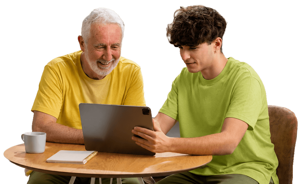 Elderly Man and Young Visitor Sharing a Tablet Together at an Independent Living Community Elderly Man and Young Visitor Sharing a Tablet Together at an Independent Living Community