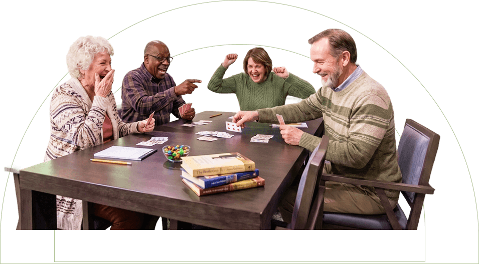 Group of Elderly Friends Laughing Together Over a Card Game at an Independent Living Community Group of Elderly Friends Laughing Together Over a Card Game at an Independent Living Community