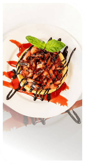 Strawberry Dessert Topped With Basil and Chocolate Drizzle at an Independent Living Facility