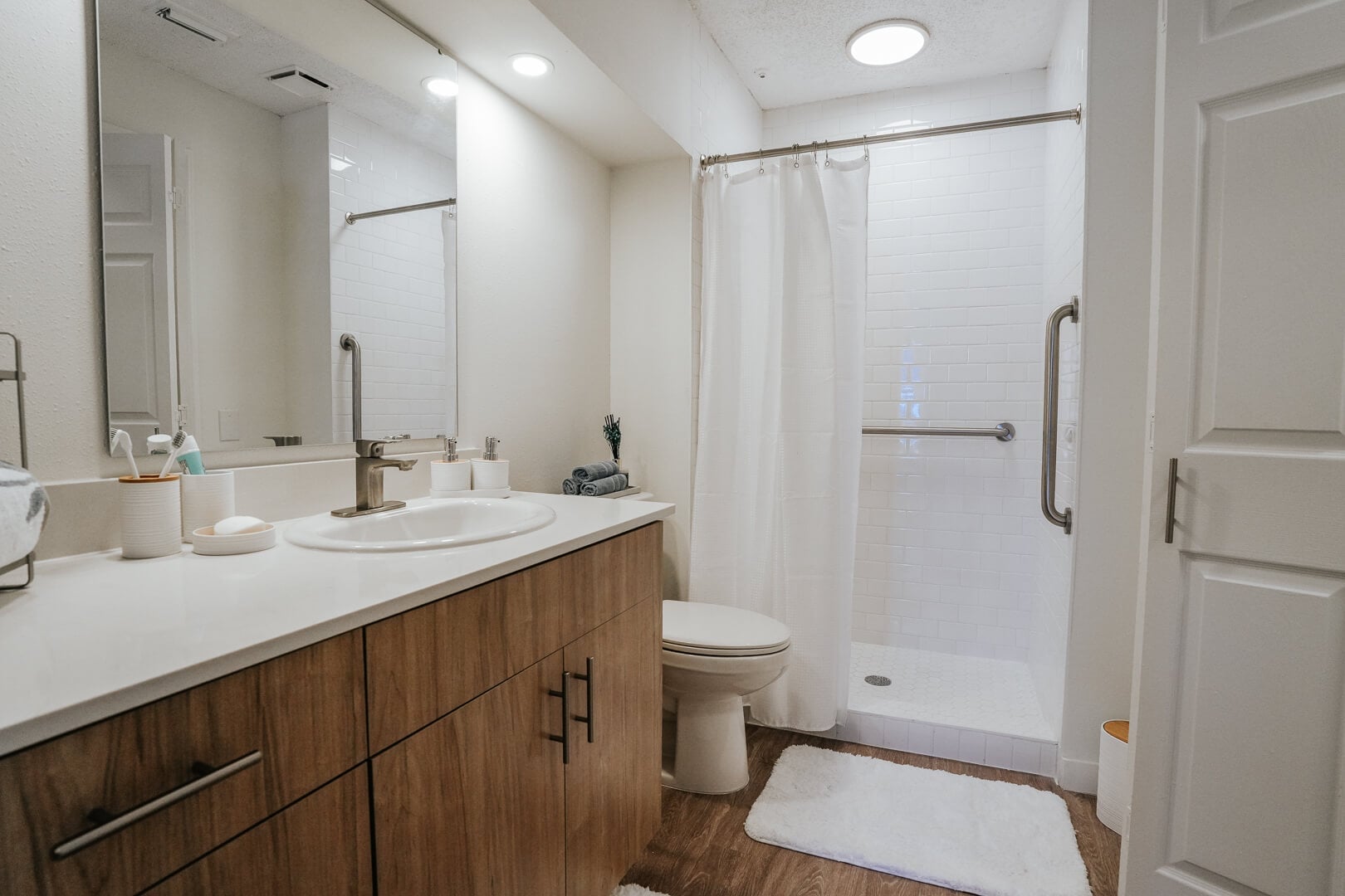 Modern Accessible Bathroom with Walk-In Shower and Grab Bars at an Independent Living Facility