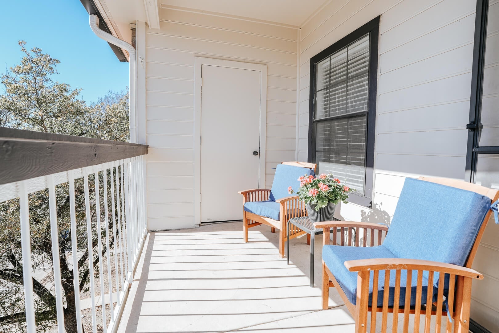 Private Balcony with Cushioned Chairs and Potted Flowers for Independent Living