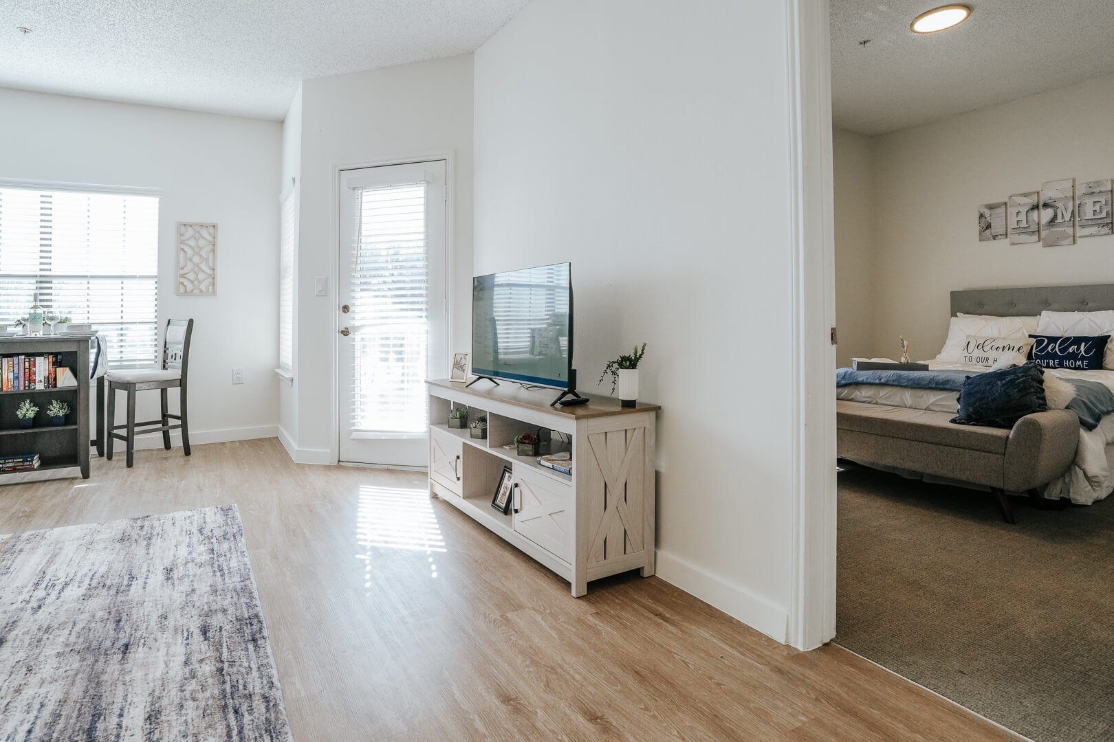 Bright Apartment Interior with Television and Bedroom View at Independent Living Community