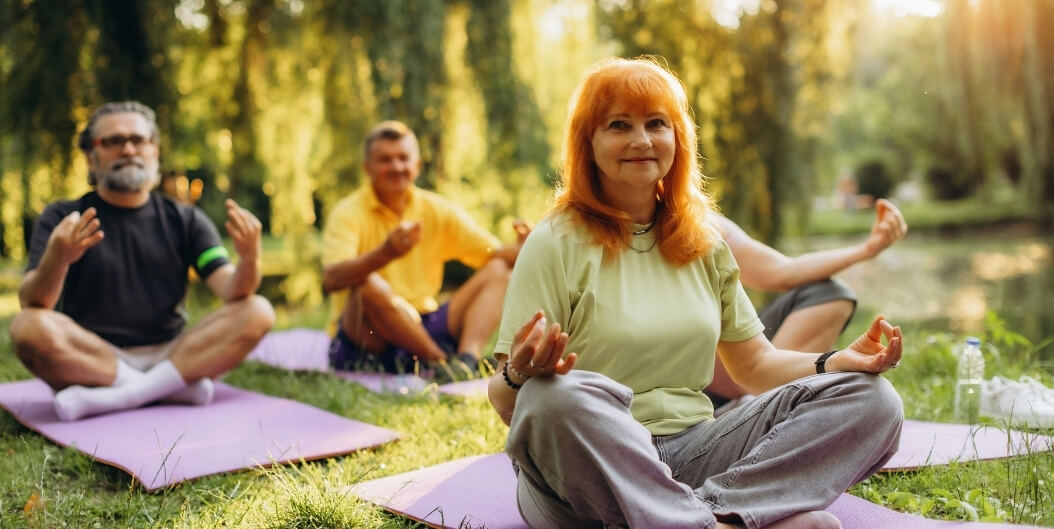 Elderly Residents Practicing Outdoor Meditation Together at Independent Facility